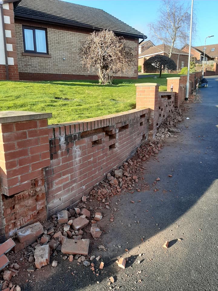 Cutting out broken bricks from a garden wall and replacing with new ones 857 individual bricks replaced.